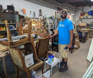 James with items in the warehouse preparing for National Thrift Shop Day 2022