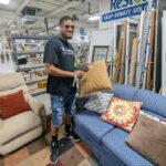 Josh pricing items for National Thrift Shop Day 2022