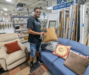 Josh pricing items for National Thrift Shop Day 2022