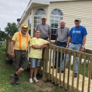 Jane Johnson and the ramp crew pose for a picture on a newly built ramp.