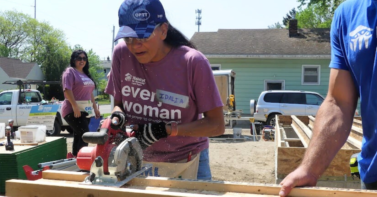 Looking back: Idalia uses a saw during Women Build.