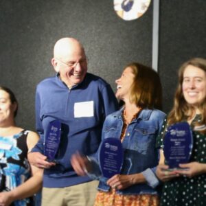 Volunteer award recipients Mike Schilling and Karen Lockwood share a laugh during a group photo during the 2024 Heart of Habitat Gratitude Gala.