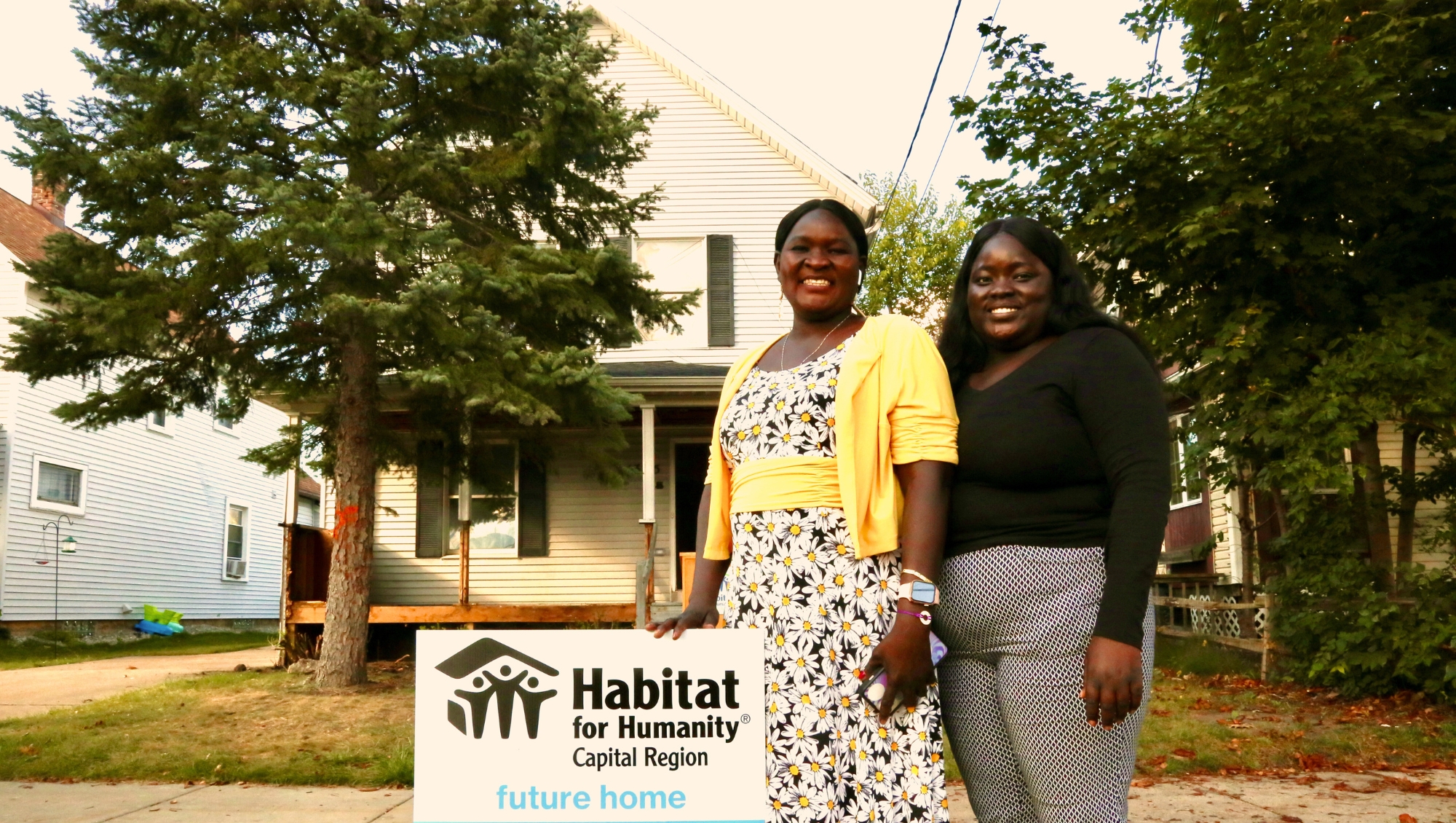 Martha and her daughter smile for a photo during their Home Blessing ceremony in summer 2024.